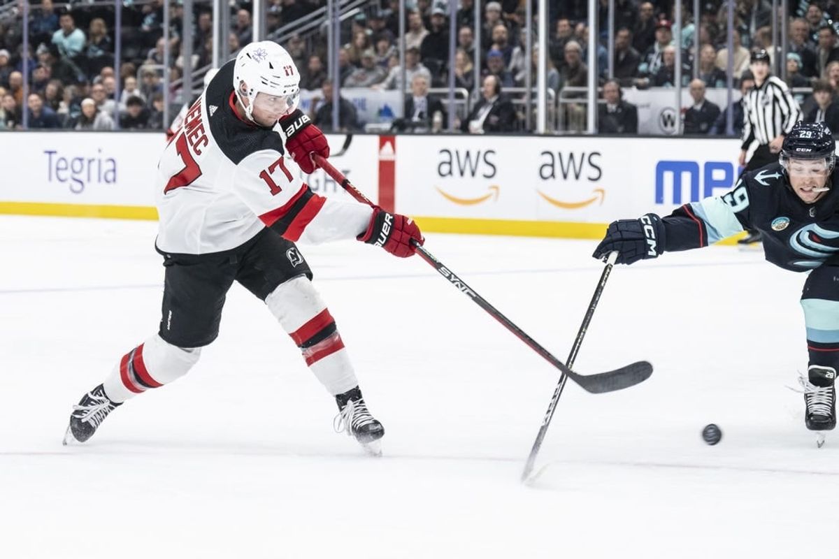 Dec 7, 2023; Seattle, Washington, USA; New Jersey Devils defenseman Simon Nemec (17) takes a shot against defenseman Vince Dunn (29) during the first period at Climate Pledge Arena.