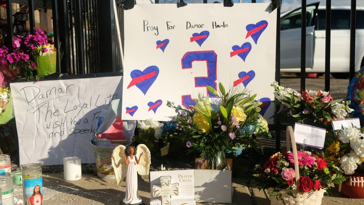 Fans hold a  vigi l for Damar Hamlin outside his hospital in Cincinnati.