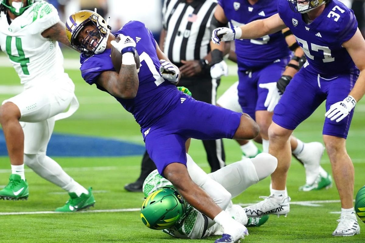 Dec 1, 2023; Las Vegas, NV, USA; Washington Huskies running back Dillon Johnson (7) gains yards against the Oregon Ducks during the first quarter at Allegiant Stadium.