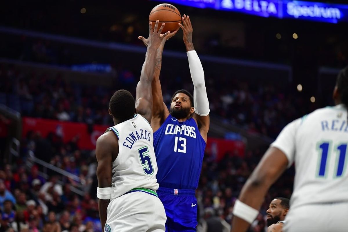 Mar 12, 2024; Los Angeles, California, USA; Los Angeles Clippers forward Paul George (13) shoots against Minnesota Timberwolves guard Anthony Edwards (5) during the second half at Crypto.com Arena.