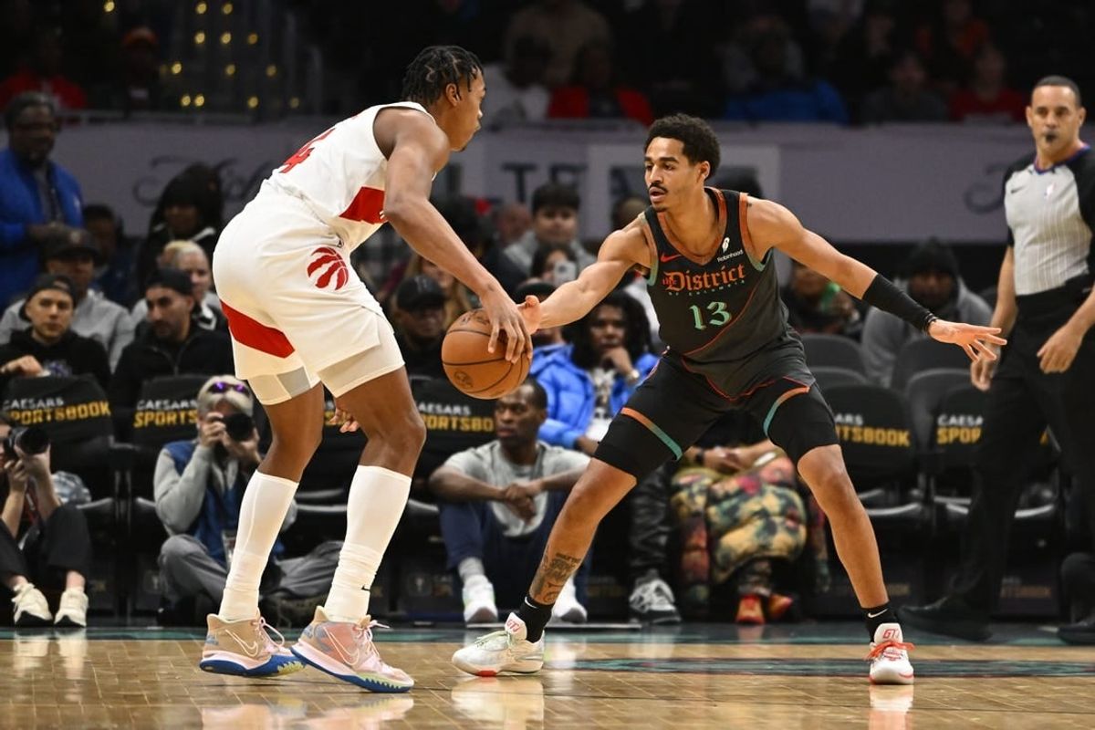 Dec 27, 2023; Washington, District of Columbia, USA; Washington Wizards guard Jordan Poole (13) defends Toronto Raptors forward Scottie Barnes (4) during the first half at Capital One Arena.