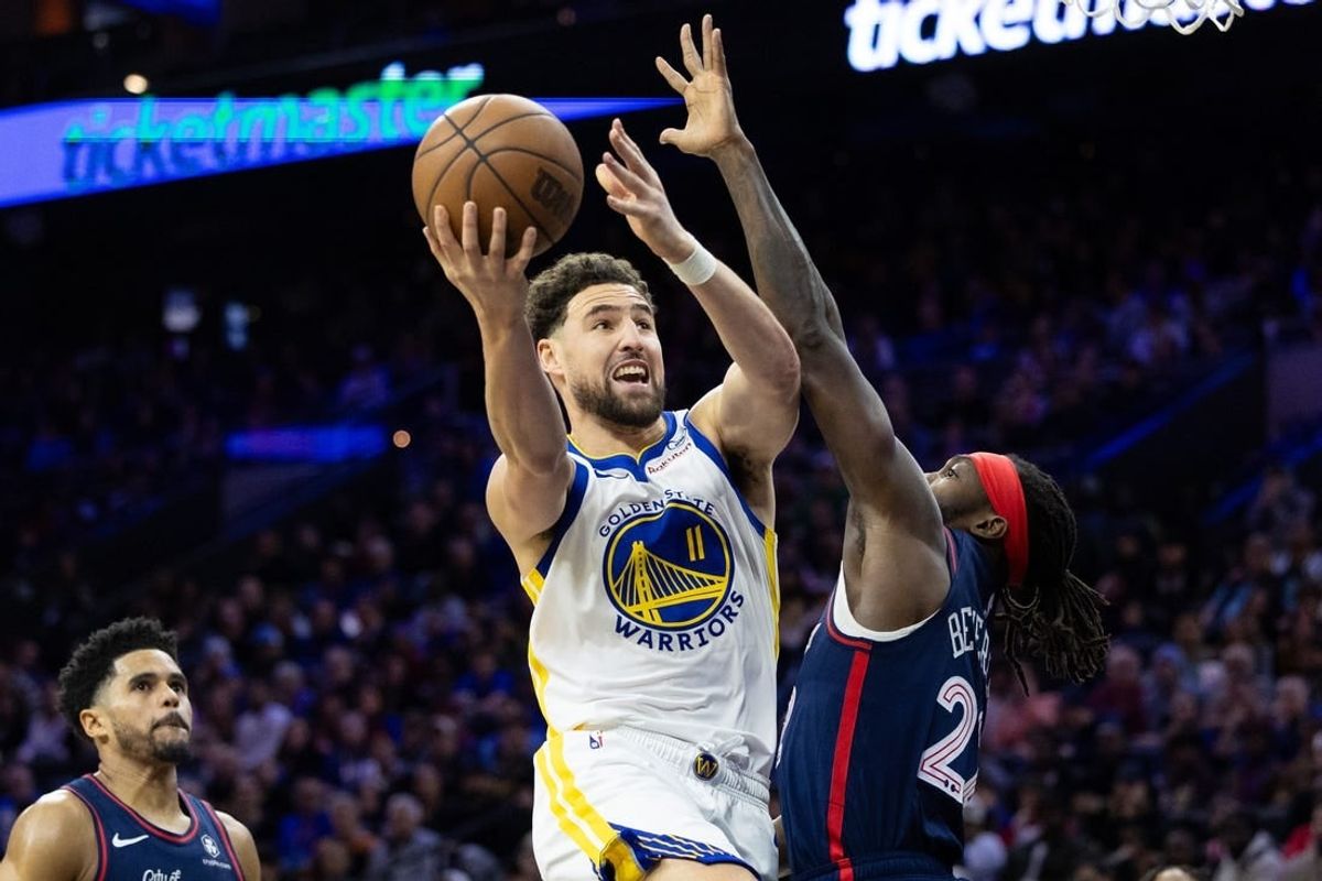 Feb 7, 2024; Philadelphia, Pennsylvania, USA; Golden State Warriors guard Klay Thompson (11) scores past Philadelphia 76ers guard Patrick Beverley (22) during the third quarter at Wells Fargo Center.