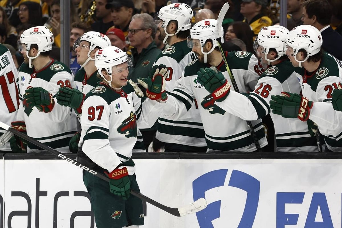 Dec 19, 2023; Boston, Massachusetts, USA; Minnesota Wild left wing Kirill Kaprizov (97) smiles as he is congratulated at the bench after scoring against the Boston Bruins during the third period at TD Garden.