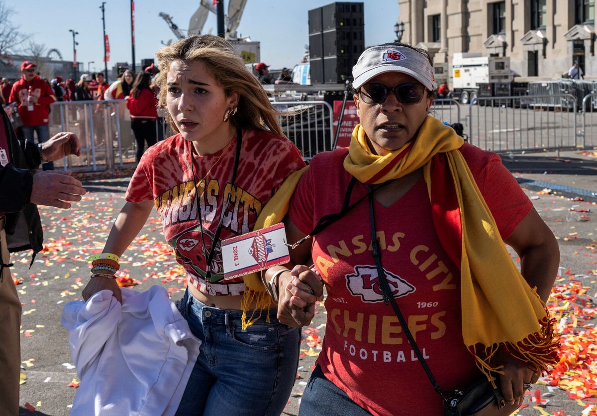 People flee after shots were fired near the Kansas City Chiefs’ Super  Bowl LVIII victory parade on Feb. 14, 2024, in Kansas City,  Missouri.