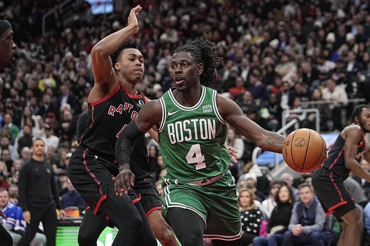 Jan 15, 2024; Toronto, Ontario, CAN; Boston Celtics guard Jrue Holiday (4) drives around Toronto Raptors forward Scottie Barnes (4) during the first half at Scotiabank Arena.