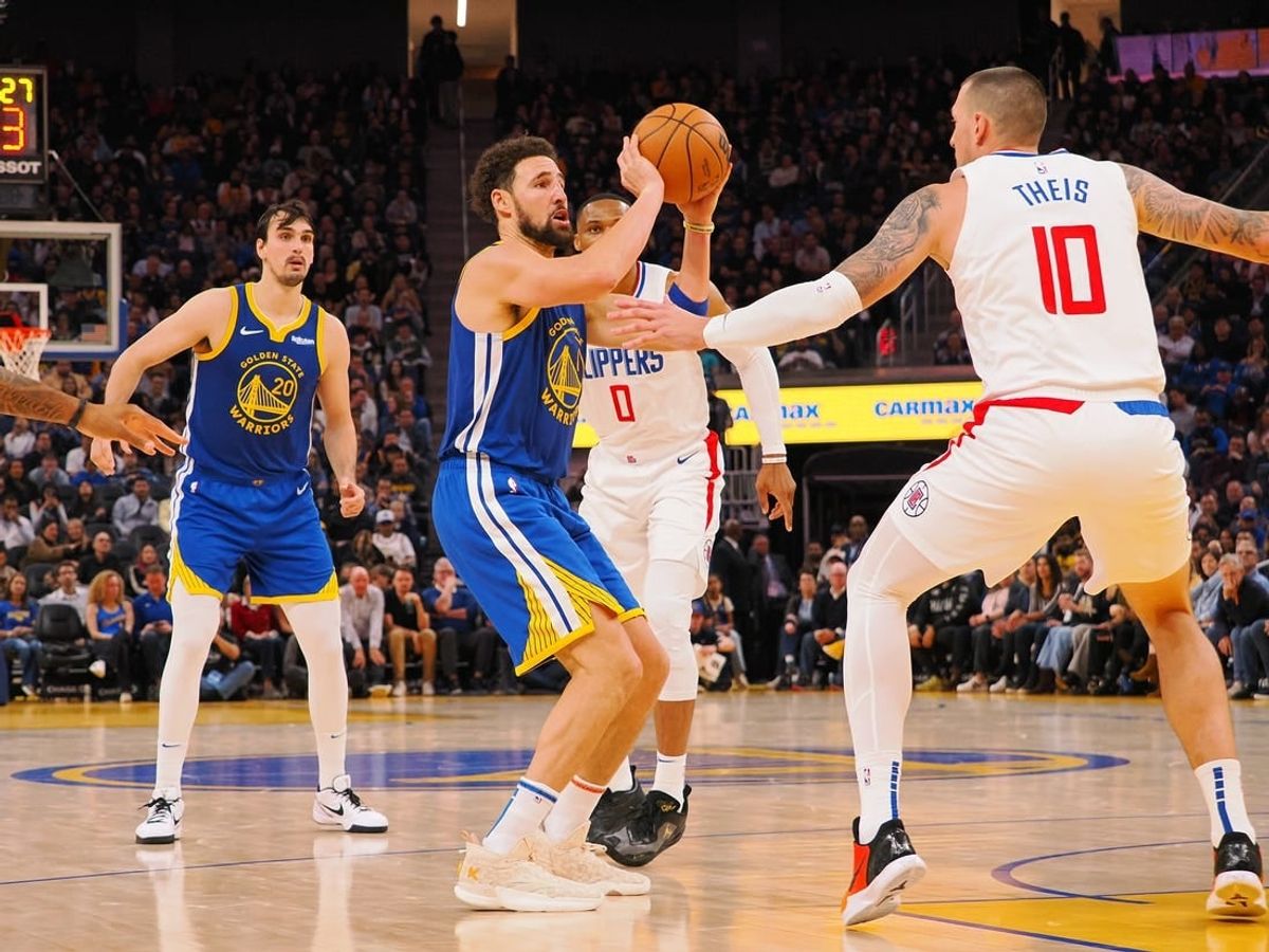 Nov 30, 2023; San Francisco, California, USA; Golden State Warriors guard Klay Thompson (11) shoots the ball against Los Angeles Clippers center Daniel Theis (10) during the fourth quarter at Chase Center.