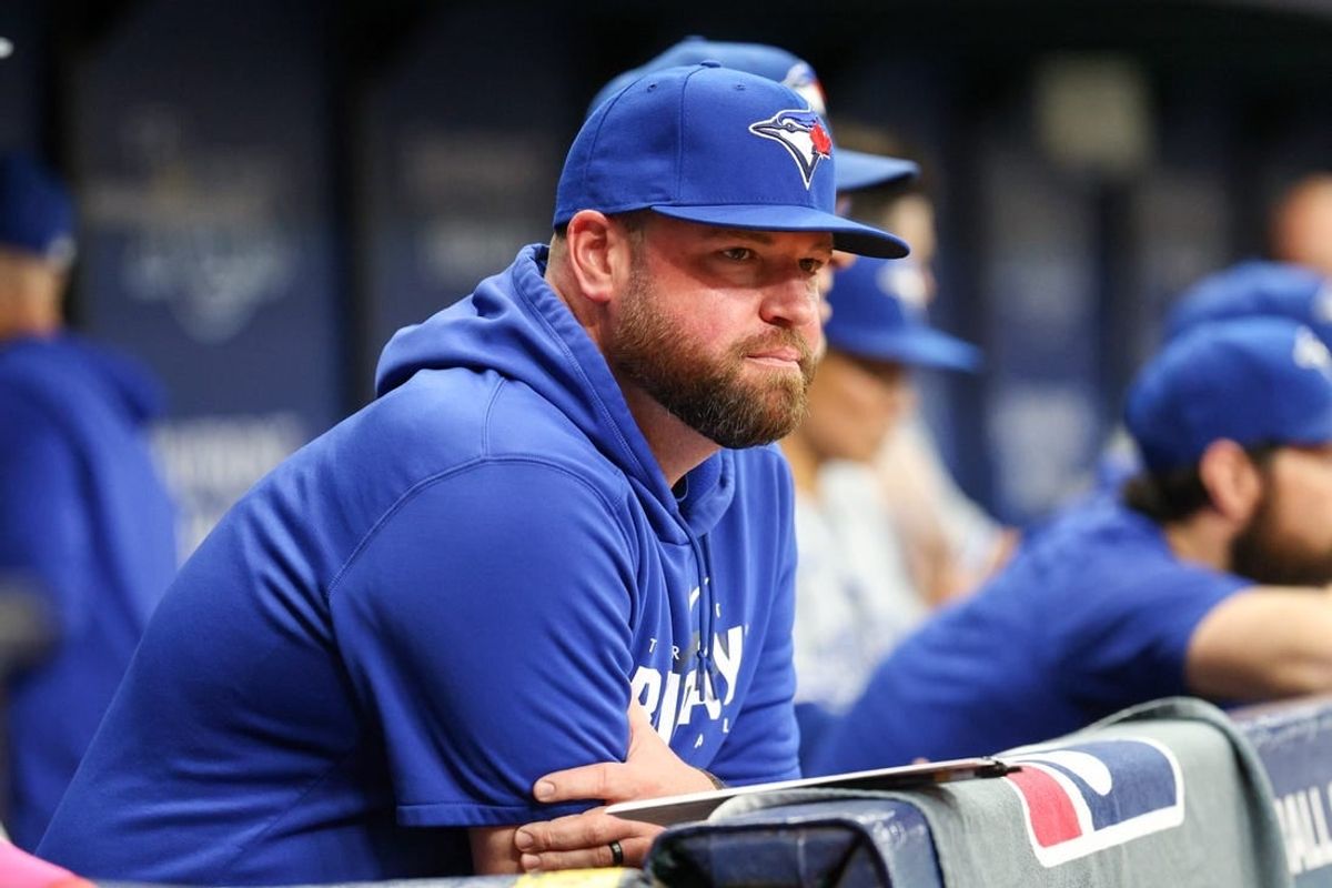 Sep 23, 2023; St. Petersburg, Florida, USA; Toronto Blue Jays manager John Schneider (14) looks on from the dugout against the Tampa Bay Rays in the eighth inning at Tropicana Field.
