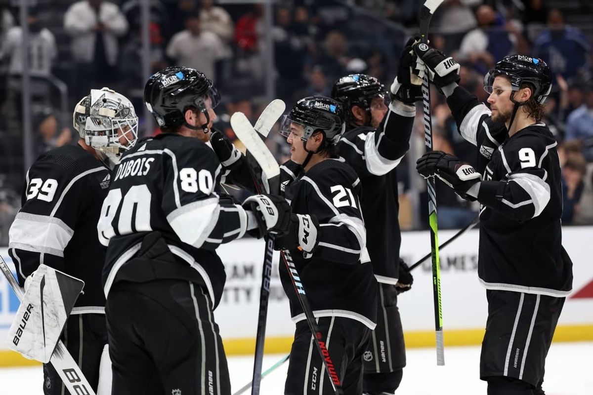 Nov 18, 2023; Los Angeles, California, USA; Los Angeles Kings center Adrian Kempe (9) high-fives with center Anze Kopitar (11) as goaltender Cam Talbot (39) and left wing Pierre-Luc Dubois (80) and defenseman Jordan Spence (21) celebrate a win after defeating the St. Louis Blues 5-1 at Crypto.com Arena.