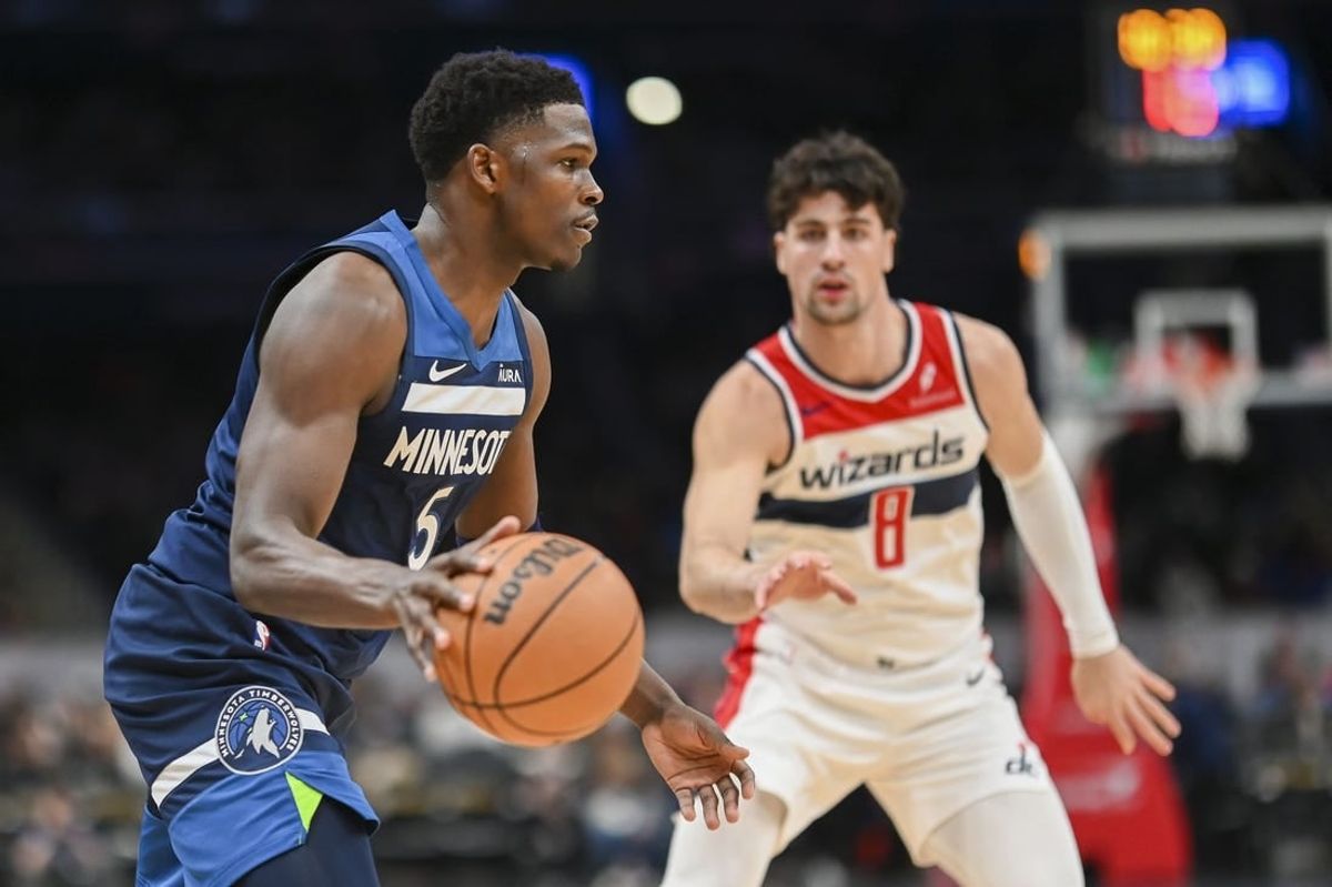 Jan 24, 2024; Washington, D.C., USA;  Minnesota Timberwolves guard Anthony Edwards (5) dribbles as Washington Wizards forward Deni Avdija (8) defends during the second half at Capital One Arena.