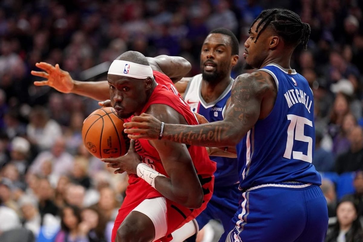 Apr 14, 2024; Sacramento, California, USA; Portland Trail Blazers center Duop Reath (26) drives to the hoop next to Sacramento Kings guard Davion Mitchell (15) in the second quarter at the Golden 1 Center.