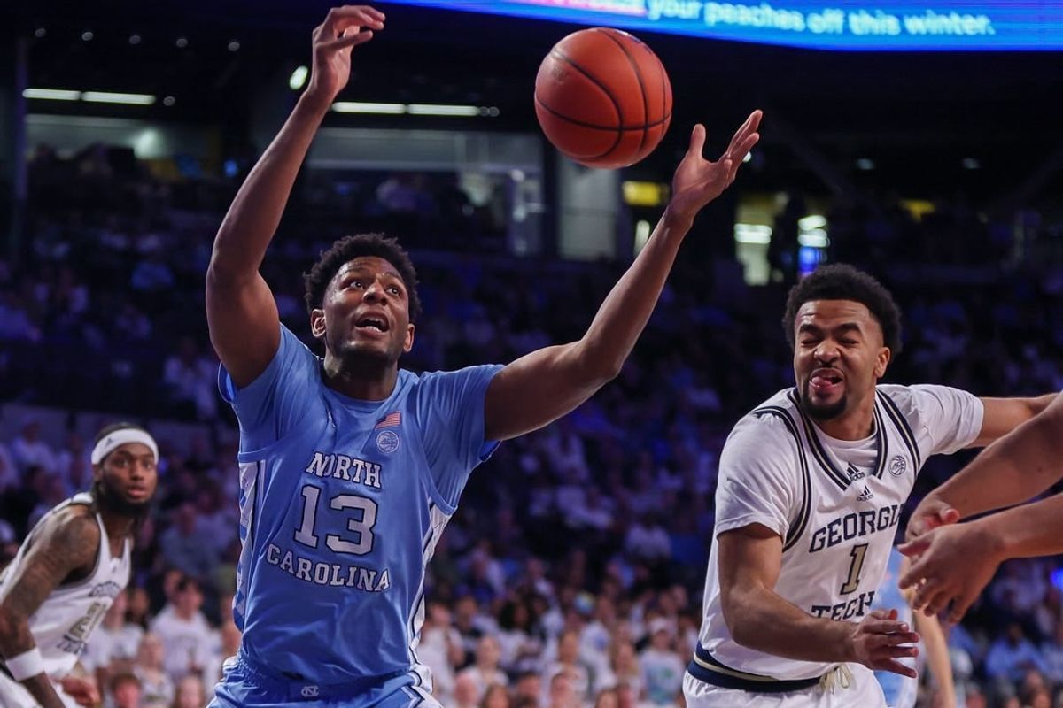 Jan 30, 2024; Atlanta, Georgia, USA; North Carolina Tar Heels forward Jalen Washington (13) and Georgia Tech Yellow Jackets guard Kyle Sturdivant (1) reach for a rebound in the first half at McCamish Pavilion.