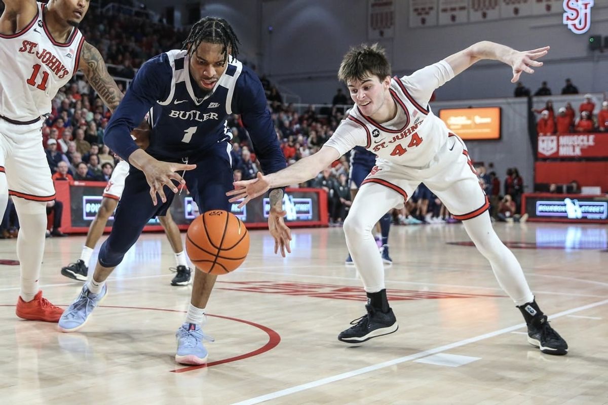 Jan 2, 2024; Queens, New York, USA; Butler Bulldogs forward Jalen Thomas (1) and St. John's Red Storm forward Brady Dunlap (44) fight for a loose ball in the first half at Carnesecca Arena.