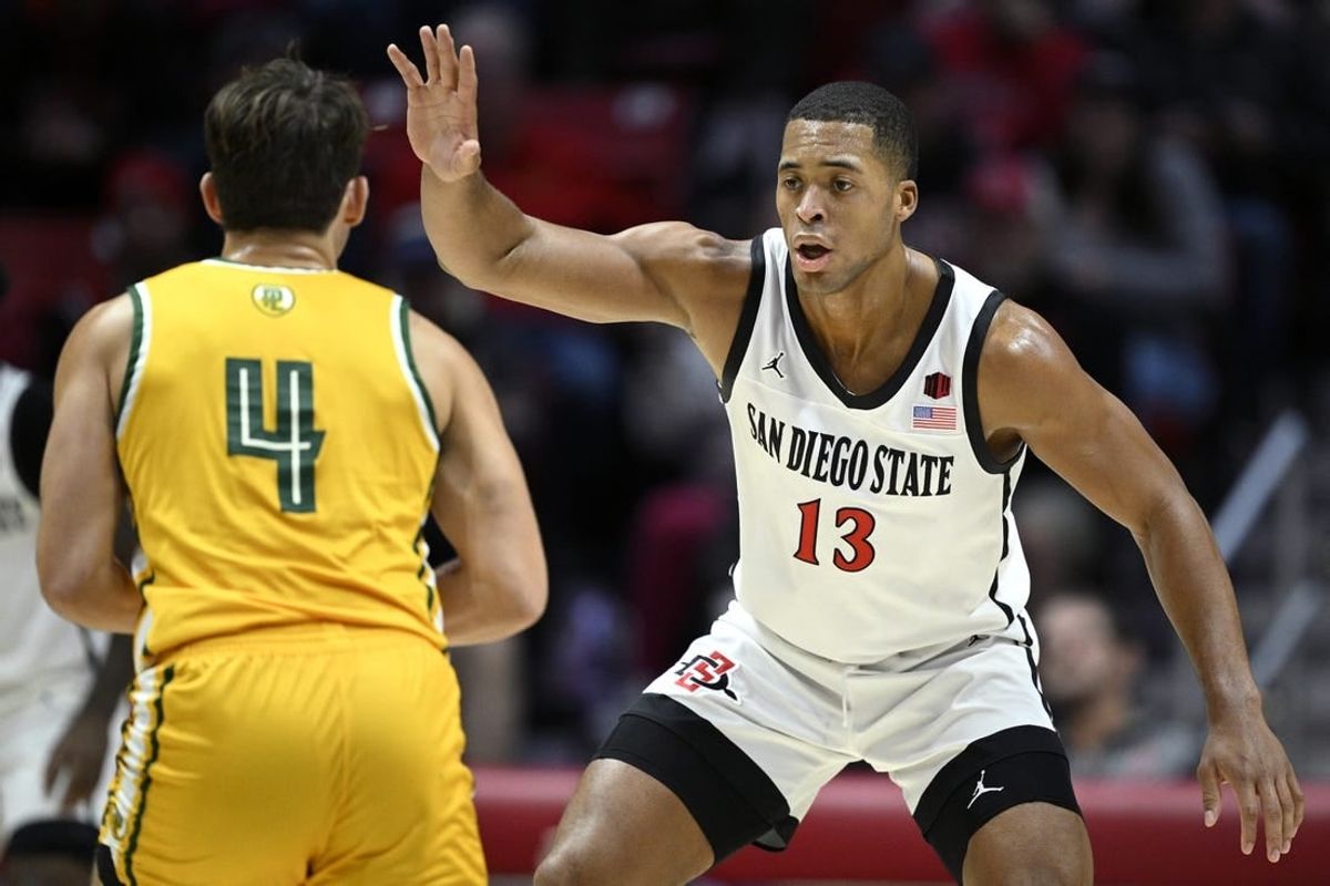 Nov 27, 2023; San Diego, California, USA; San Diego State Aztecs forward Jaedon LeDee (13) defends Point Loma Nazarene Sea Lions guard Coby Barnes (4) during the first half at Viejas Arena.