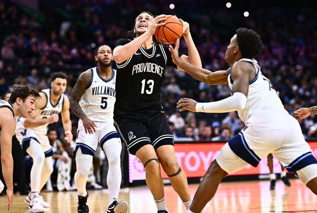 Feb 4, 2024; Philadelphia, Pennsylvania, USA; Providence Friars forward Josh Oduro (13) drives against Villanova Wildcats guard Jordan Longino (15) in the first half at Wells Fargo Center.