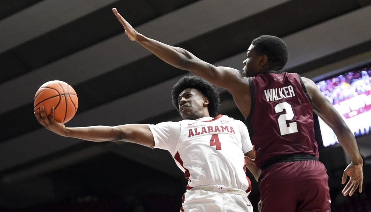 Dec 23, 2023; Tuscaloosa, Alabama, USA;  Alabama guard Davin Cosby Jr. (4) attempts a shot inside with Eastern Kentucky guard Leland Walker (2) defending at Coleman Coliseum.
