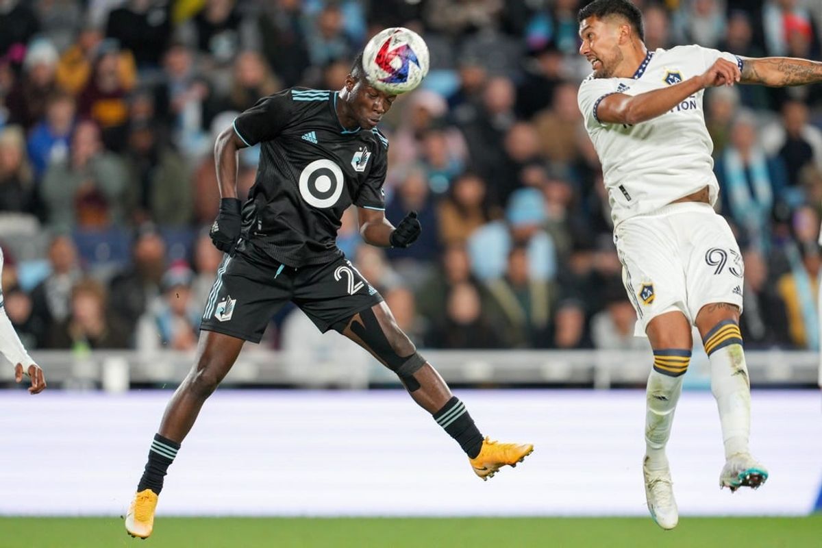 Oct 7, 2023; Saint Paul, Minnesota, USA; Minnesota United forward Bongokuhle Hlongwane (21) heads the ball against Los Angeles Galaxy defender Tony Alfaro (93) in the first half at Allianz Field.