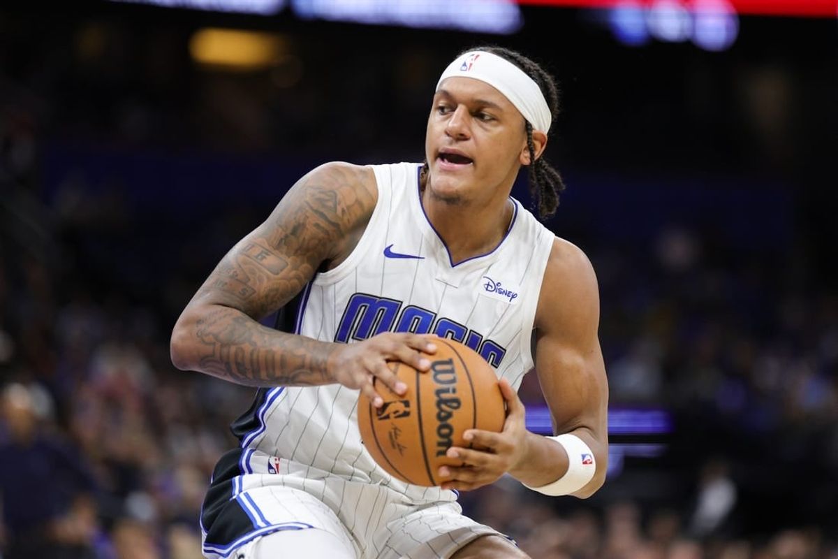 Nov 26, 2023; Orlando, Florida, USA;  Orlando Magic forward Paolo Banchero (5) controls the ball against the Charlotte Hornets in the second quarter at Amway Center.