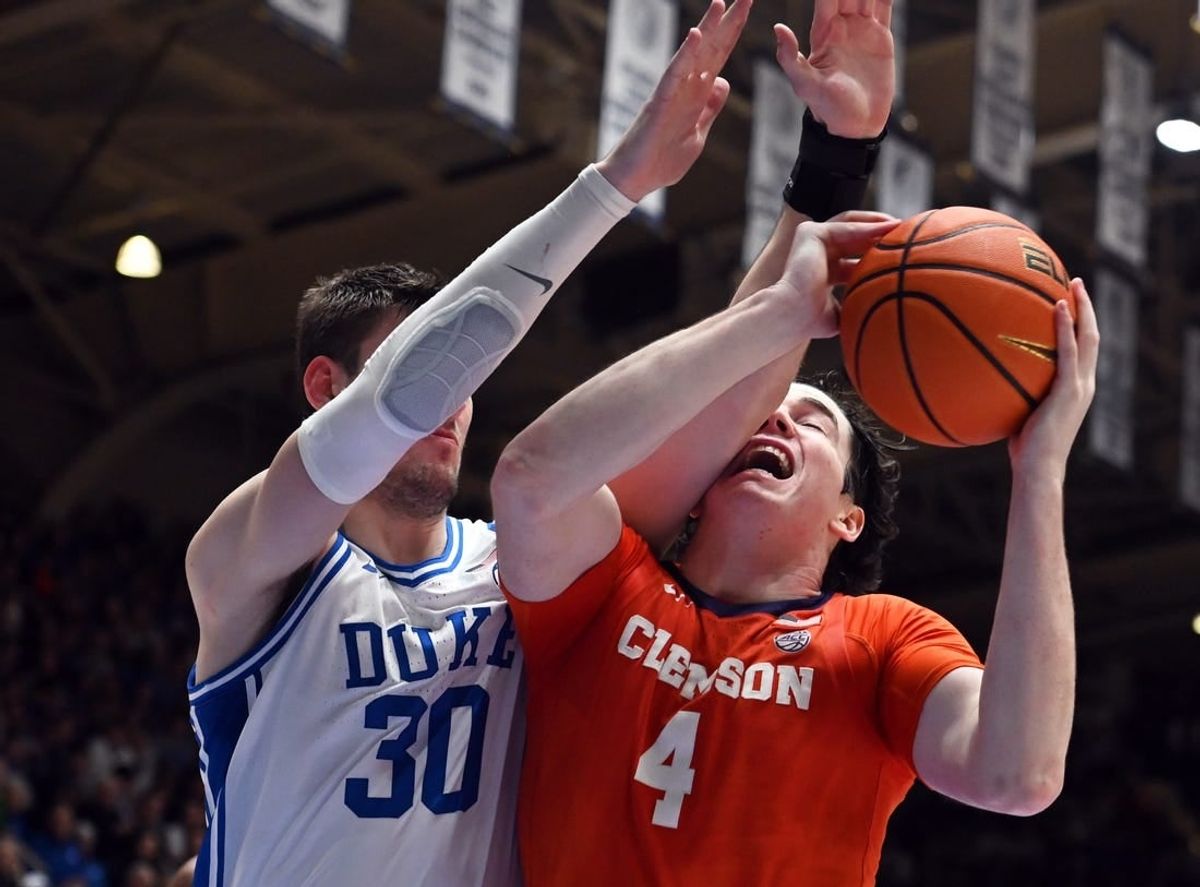 Jan 27, 2024; Durham, North Carolina, USA; Clemson Tigers forward Ian Schiefflelin (4) attempts to shot s Duke Blue Devils center Kyle Filipowski (30) defends during the first half at Cameron Indoor Stadium.