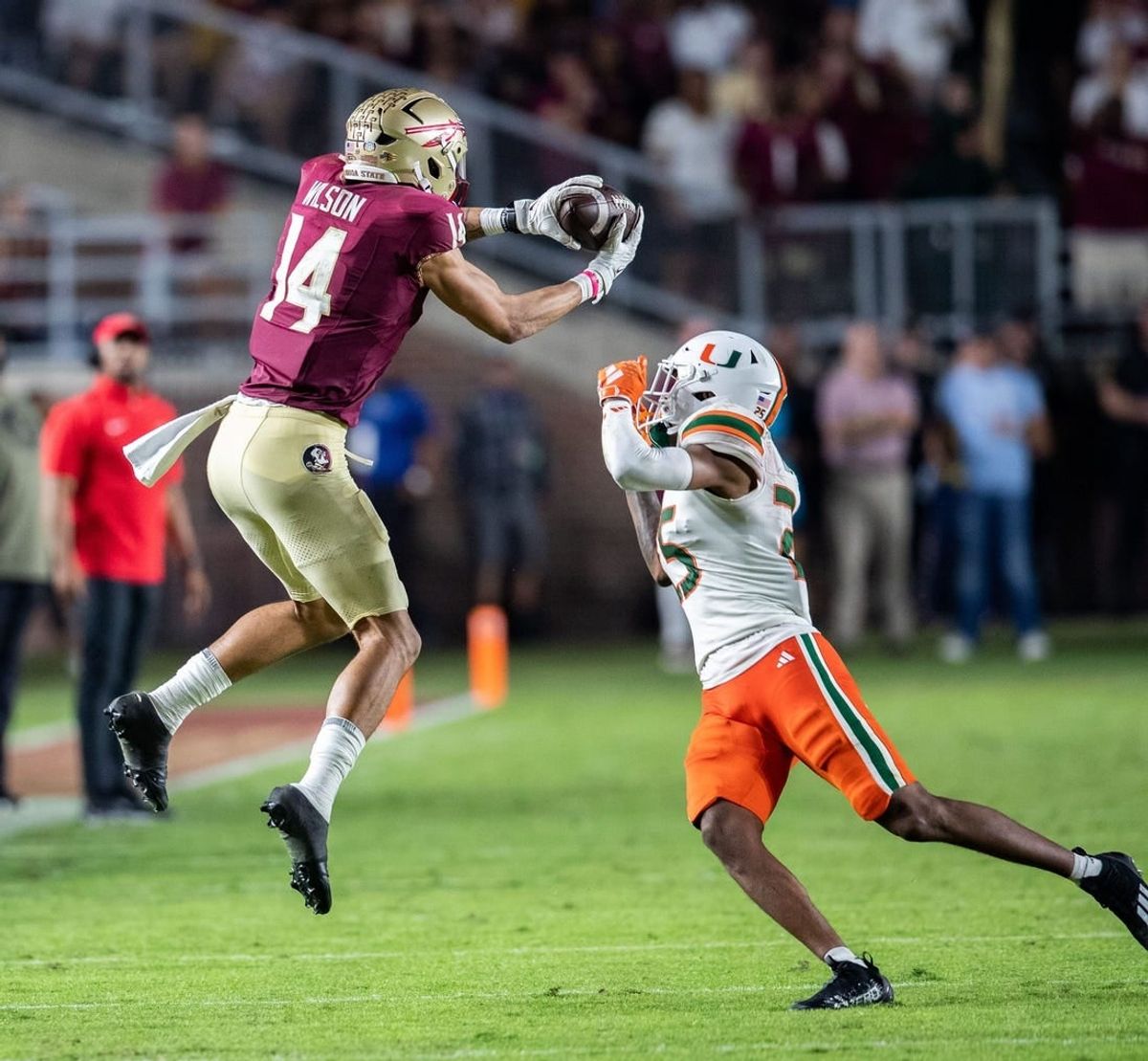 Florida State Seminoles wide receiver Johnny Wilson (14) catches a pass from Florida State Seminoles quarterback Jordan Travis (13). The Florida State Seminoles defeated the Miami Hurricanes 27-20 on Saturday, Nov. 11, 2023.