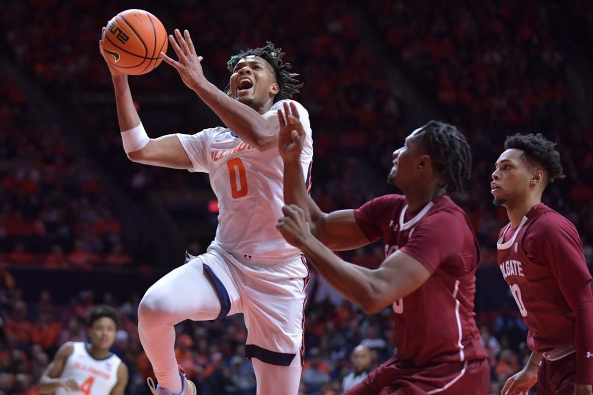 Dec 17, 2023; Champaign, Illinois, USA;  Illinois Fighting Illini guard Terrence Shannon Jr. (0) drives to the basket against Colgate Raiders players during the first half at State Farm Center.