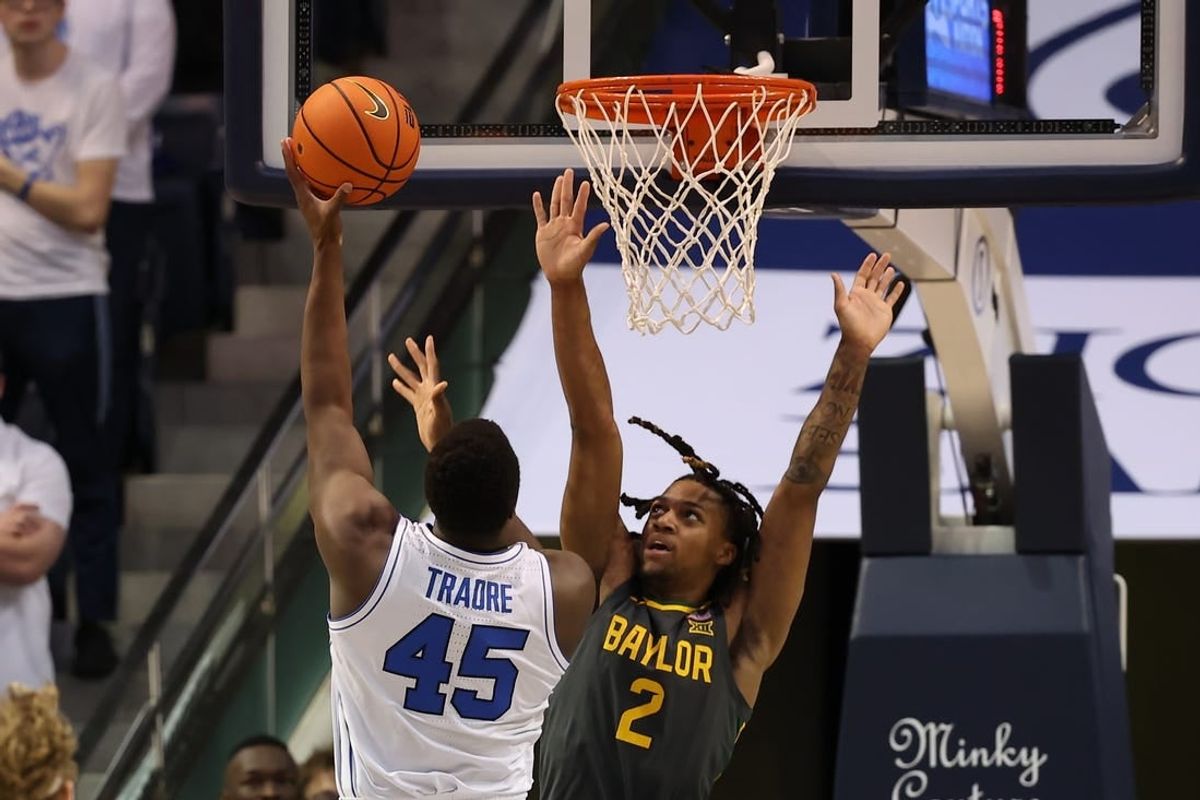 Feb 20, 2024; Provo, Utah, USA; Brigham Young Cougars forward Fousseyni Traore (45) shoots over Baylor Bears guard Jayden Nunn (2) during the second half at Marriott Center.