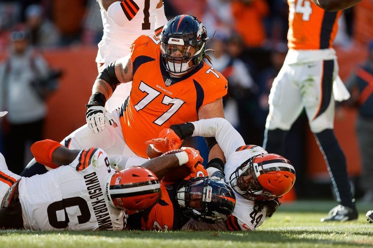 Nov 26, 2023; Denver, Colorado, USA; Denver Broncos running back Samaje Perine (25) scores a touchdown against Cleveland Browns linebacker Jeremiah Owusu-Koramoah (6) and linebacker Sione Takitaki (44) after being pushed into the end zone by guard Quinn Meinerz (77) in the first quarter at Empower Field at Mile High.