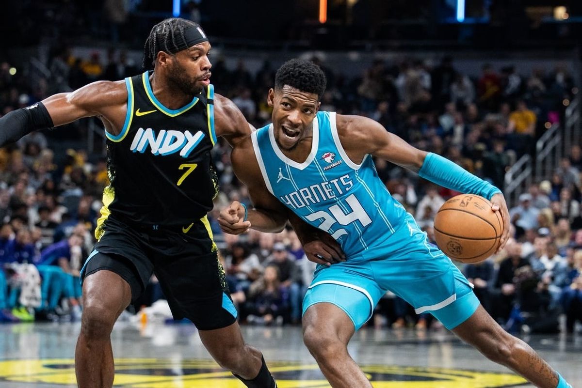 Dec 20, 2023; Indianapolis, Indiana, USA; Charlotte Hornets forward Brandon Miller (24) dribbles the ball while Indiana Pacers guard Buddy Hield (7) defends in the second quarter at Gainbridge Fieldhouse.