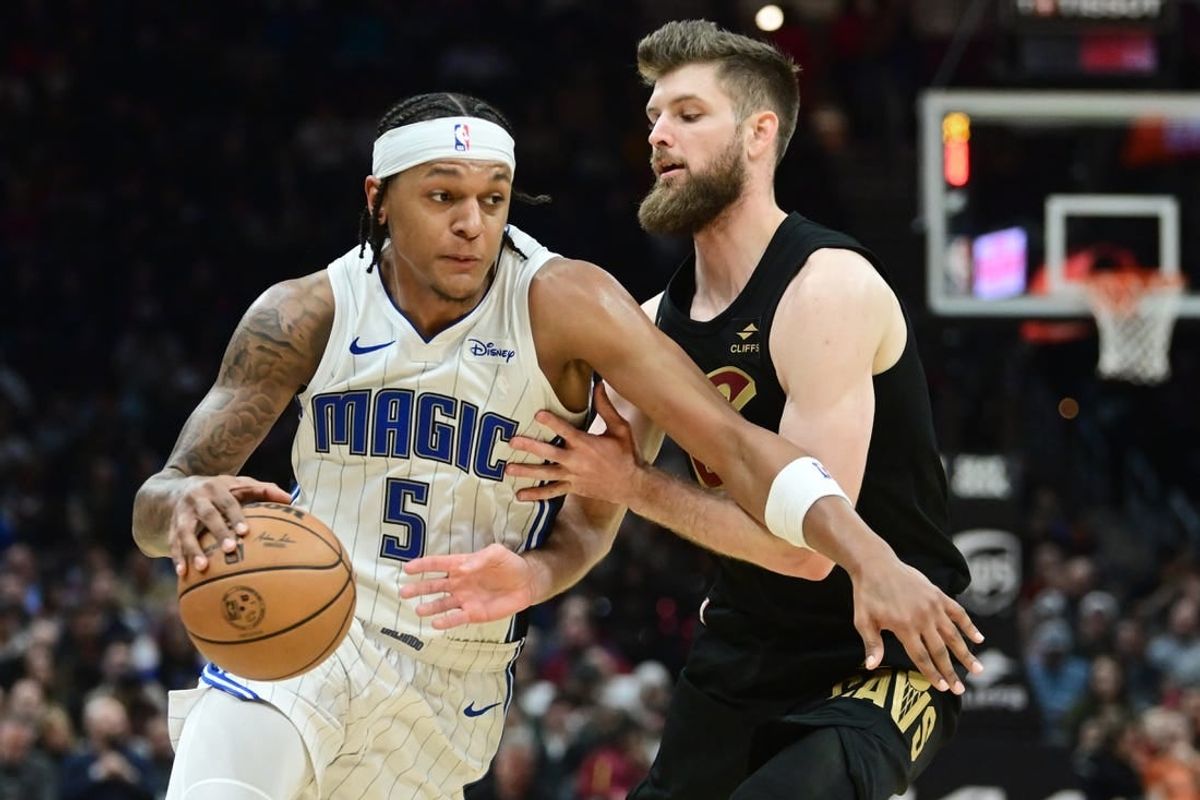 Dec 6, 2023; Cleveland, Ohio, USA; Orlando Magic forward Paolo Banchero (5) drives to the basket against Cleveland Cavaliers forward Dean Wade (32) during the first half at Rocket Mortgage FieldHouse.