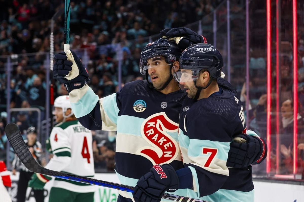 Feb 24, 2024; Seattle, Washington, USA; Seattle Kraken right wing Jordan Eberle (7) celebrates with center Matty Beniers (10) after scoring a goal against the Minnesota Wild during the third period at Climate Pledge Arena.
