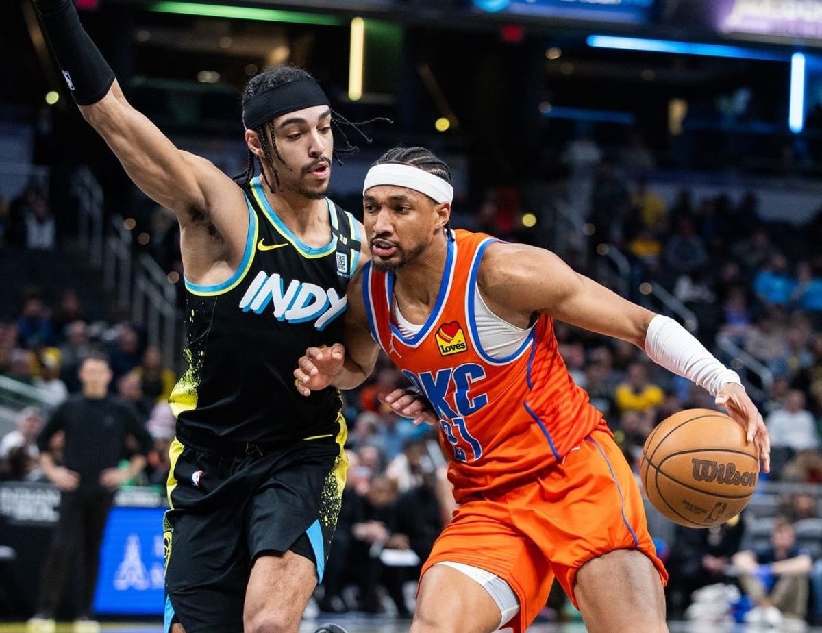 Apr 5, 2024; Indianapolis, Indiana, USA; Oklahoma City Thunder guard Aaron Wiggins (21) dribbles the ball while Indiana Pacers guard Andrew Nembhard (2) defends in the second half at Gainbridge Fieldhouse.
