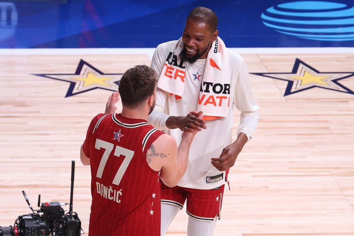 Feb 18, 2024; Indianapolis, Indiana, USA; Western Conference forward Luka Doncic (77) of the Dallas Mavericks shakes hands with forward Kevin Durant (35) of the Phoenix Suns following the 73rd NBA All Star game against the Eastern Conference All-Stars at Gainbridge Fieldhouse.