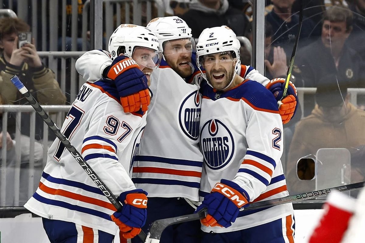 Mar 5, 2024; Boston, Massachusetts, USA; Edmonton Oilers center Leon Draisaitl (29) celebrates his game winning overtime goal against the Boston Bruins with teammates center Connor McDavid (97) and defenseman Evan Bouchard (2) at TD Garden.