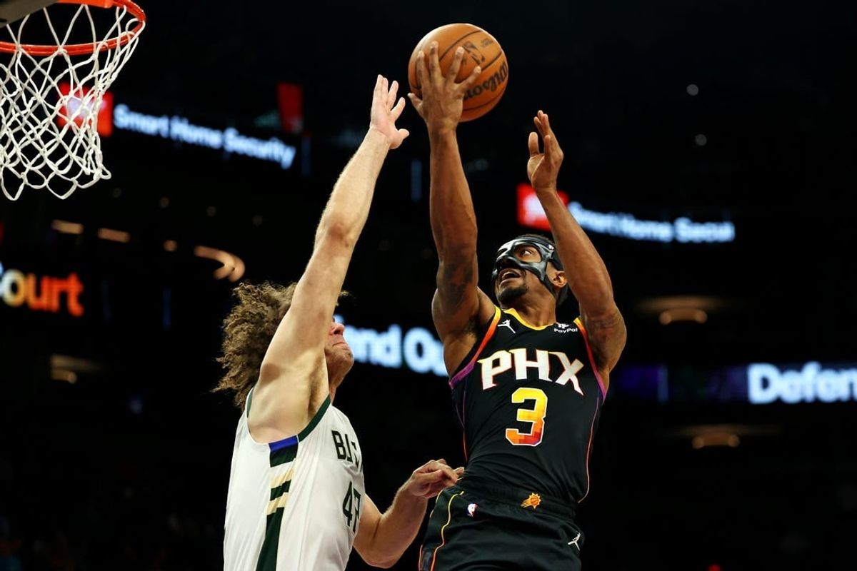 Feb 6, 2024; Phoenix, Arizona, USA; Phoenix Suns guard Bradley Beal (3) shoots the ball against Milwaukee Bucks center Robin Lopez (42) during the third quarter at Footprint Center.