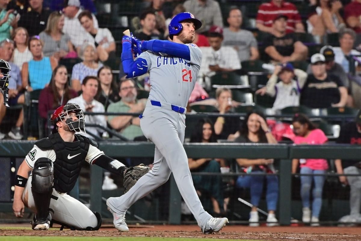 Apr 17, 2024; Phoenix, Arizona, USA;  Chicago Cubs outfielder Cody Bellinger (24) hits a solo home run in the sixth inning against the Arizona Diamondbacks at Chase Field.