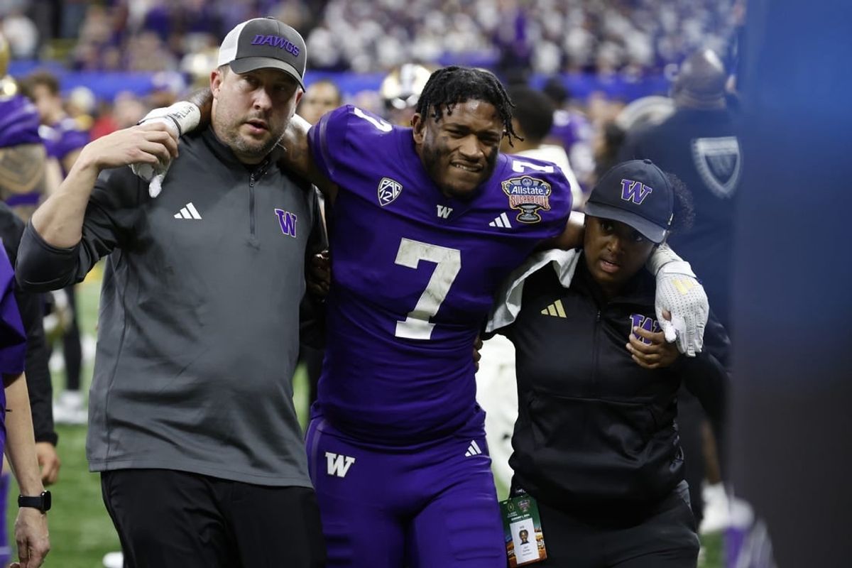 Jan 1, 2024; New Orleans, LA, USA; Washington Huskies running back Dillon Johnson (7) is helped into the medical examination tent after being injured against the Texas Longhorns in the 2024 Sugar Bowl college football playoff semifinal game at Caesars Superdome.