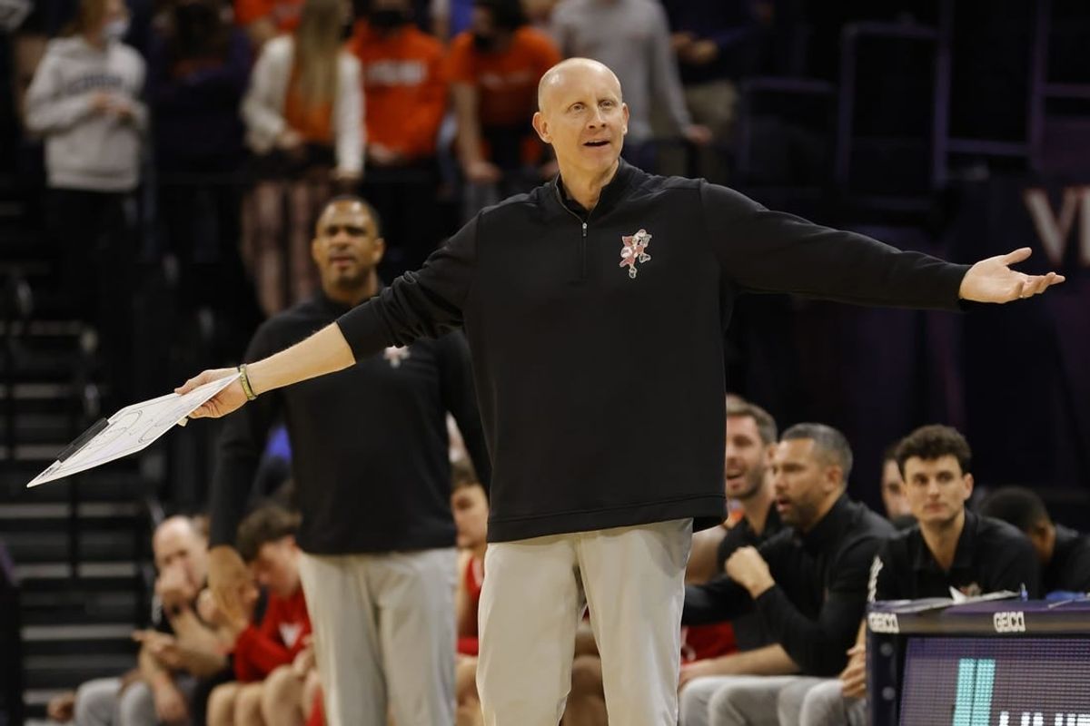 Jan 24, 2022; Charlottesville, Virginia, USA; Louisville Cardinals head coach Chris Mack gestures to a referee from the bench against the Virginia Cavaliers during the first half at John Paul Jones Arena.