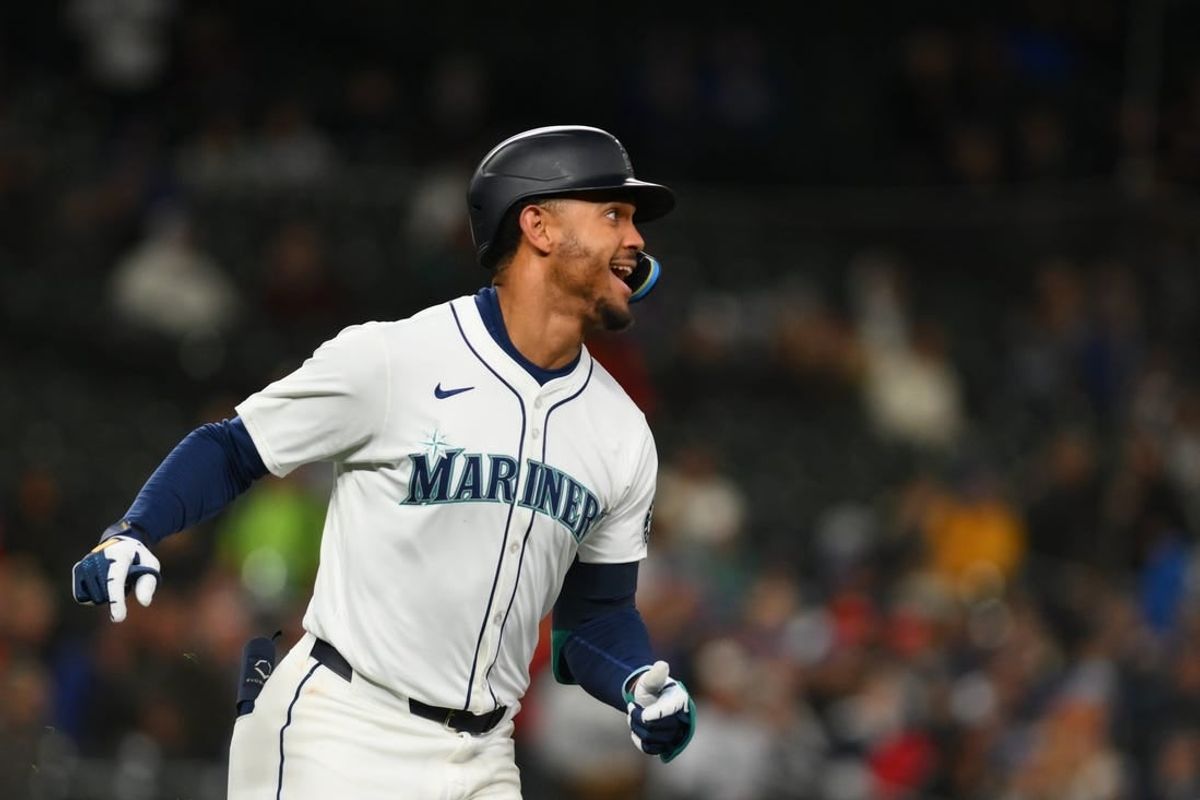 Apr 15, 2024; Seattle, Washington, USA; Seattle Mariners center fielder Julio Rodriguez runs towards first base after hitting a single against the Cincinnati Reds during the seventh inning at T-Mobile Park. All players wore #42 in honor of Jackie Robinson Day.