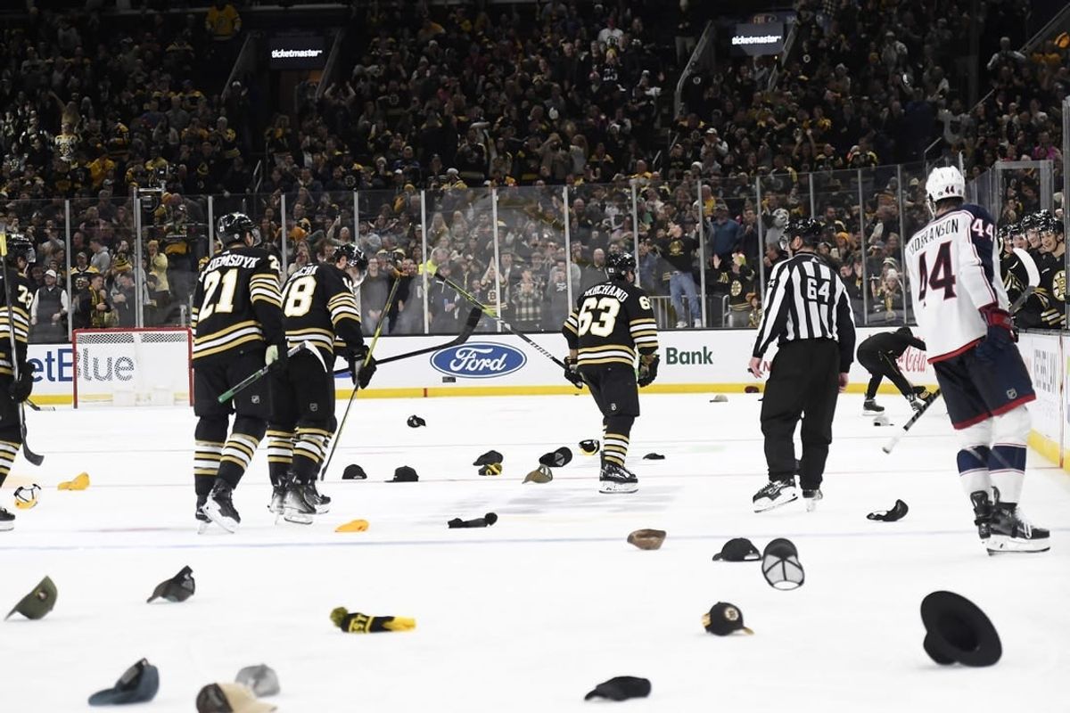 Dec 3, 2023; Boston, Massachusetts, USA; Boston Bruins left wing Brad Marchand (63) celebrates his third goal as fans throw their hats on the ice for his    hat trick    during the third period against the Columbus Blue Jackets at TD Garden.
