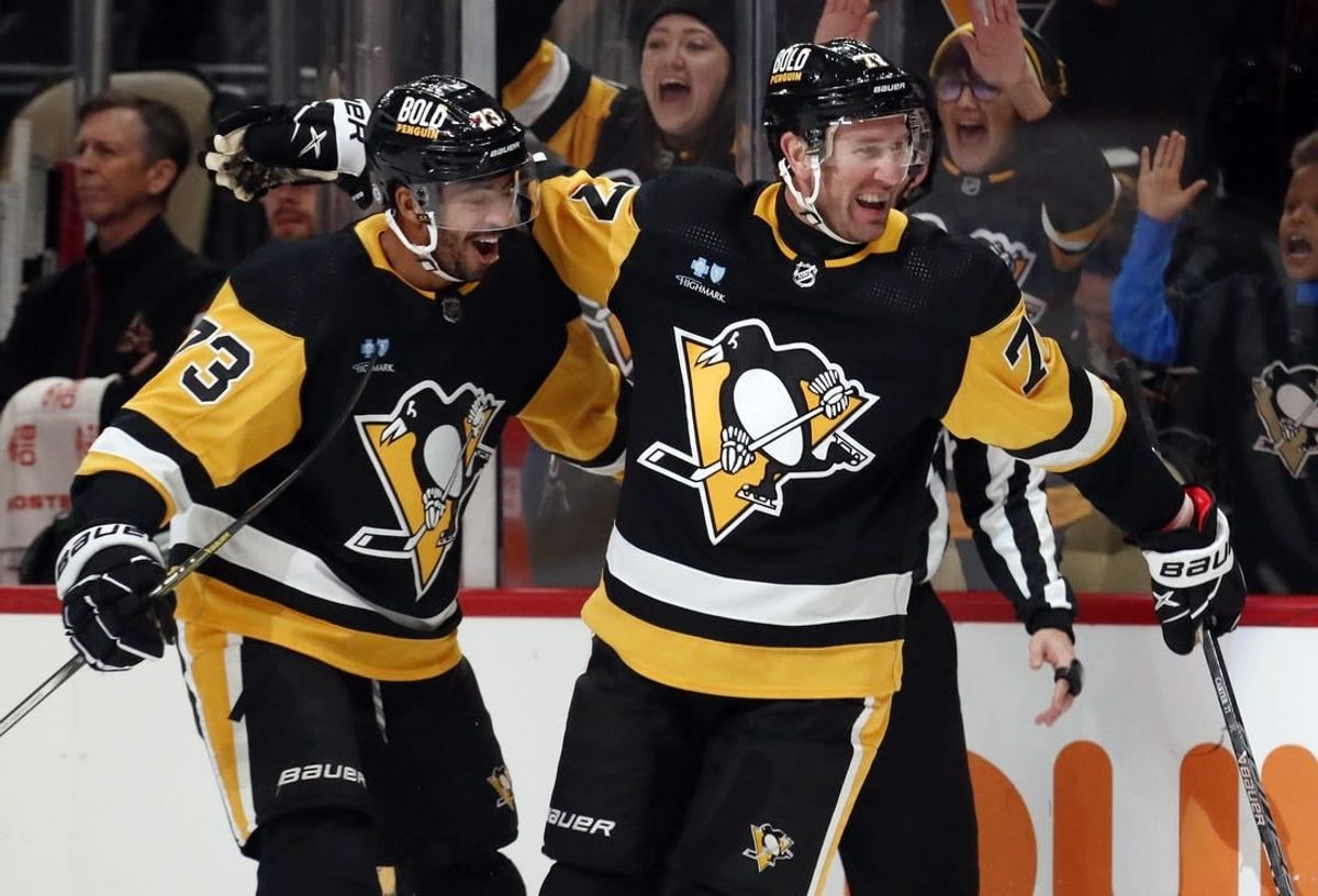 Dec 12, 2023; Pittsburgh, Pennsylvania, USA; Pittsburgh Penguins center Jeff Carter (77) reacts with defenseman Pierre-Olivier Joseph (73) after Carter scored a short-handed goal against the Arizona Coyotes during the first period at PPG Paints Arena. Pittsburgh won 4-2.