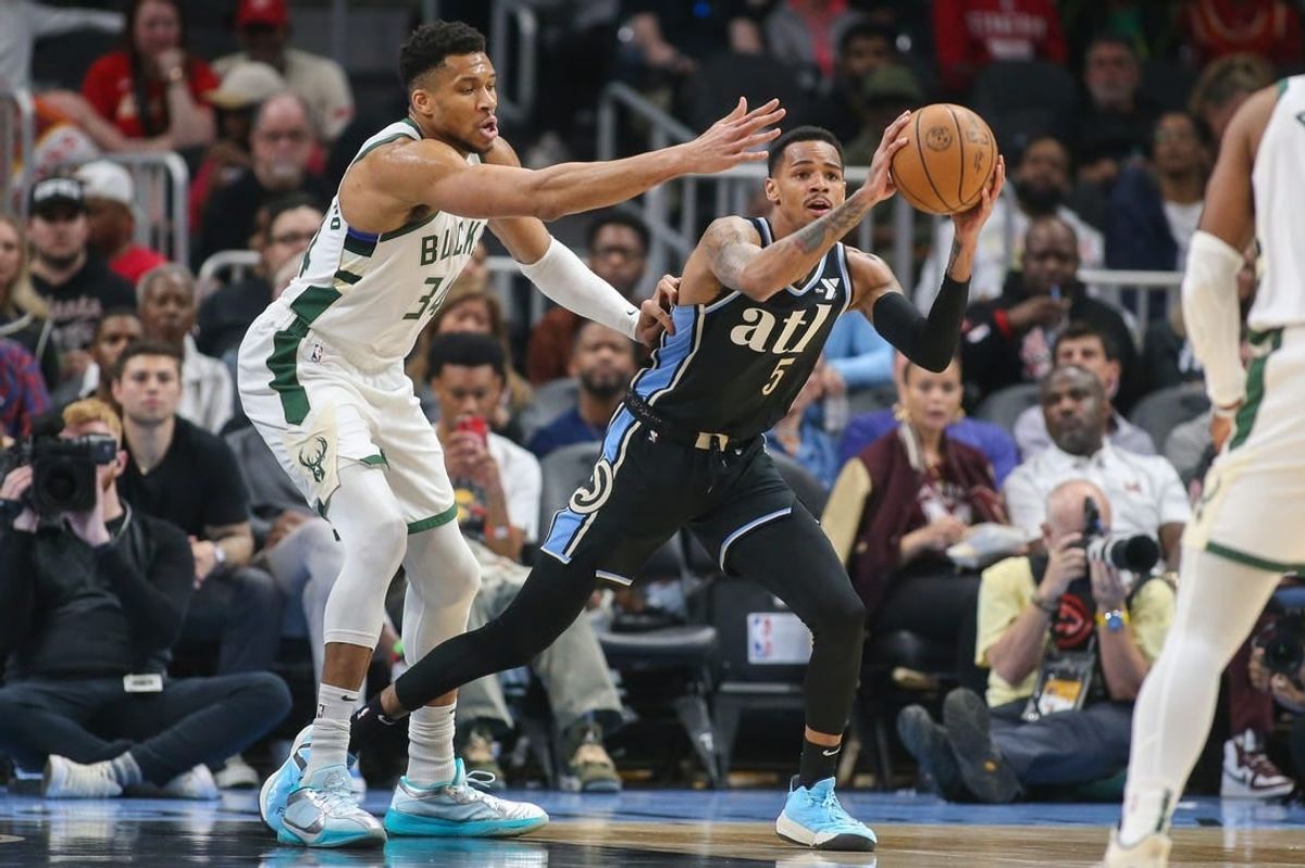 Mar 30, 2024; Atlanta, Georgia, USA; Milwaukee Bucks forward Giannis Antetokounmpo (34) defends Atlanta Hawks guard Dejounte Murray (5) in the first quarter at State Farm Arena.