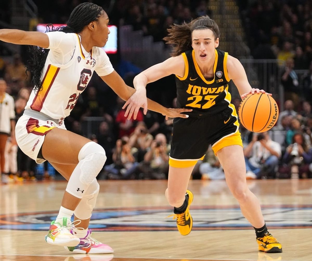 Iowa Hawkeyes guard Caitlin Clark (22) drives to the basket as South Carolina Gamecocks guard Bree Hall (23) defends during the NCAA Tournament championship basketball game at Rocket Mortgage Fieldhouse, Sunday, April 7, 2024 in Cleveland.