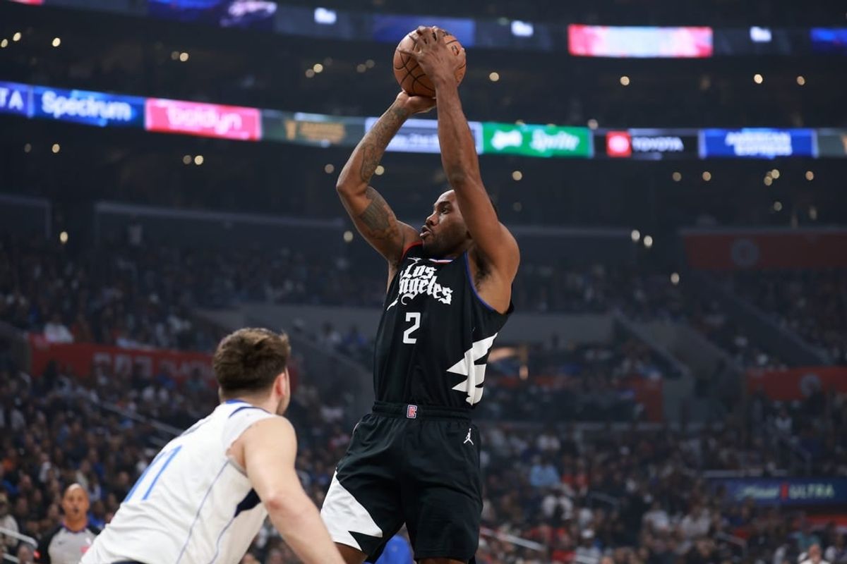 Apr 23, 2024; Los Angeles, California, USA; Los Angeles Clippers forward Kawhi Leonard (2) shoots the ball over Dallas Mavericks guard Luka Doncic (77) in the first quarter of game two of the first round for the 2024 NBA playoffs at Crypto.com Arena.