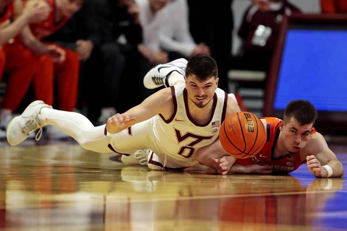 Jan 10, 2024; Blacksburg, Virginia, USA; Virginia Tech Hokies guard Hunter Cattoor (0) and Clemson Tigers guard Joseph Girard III (11) go for the ball during the first half at Cassell Coliseum.