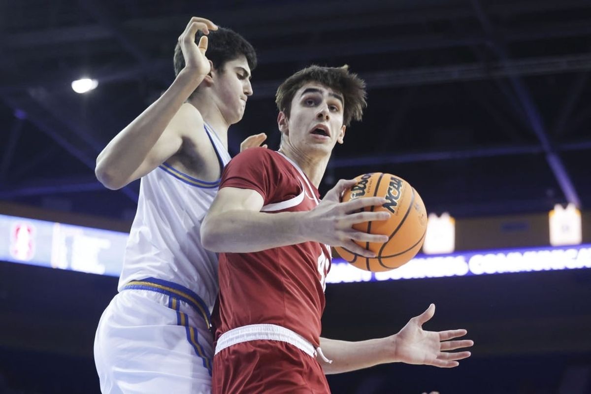 Jan 3, 2024; Los Angeles, California, USA; Stanford Cardinal forward Maxime Raynaud (42) catches the ball as UCLA center Aday Mara (15) defends during the first half at Pauley Pavilion presented by Wescom.