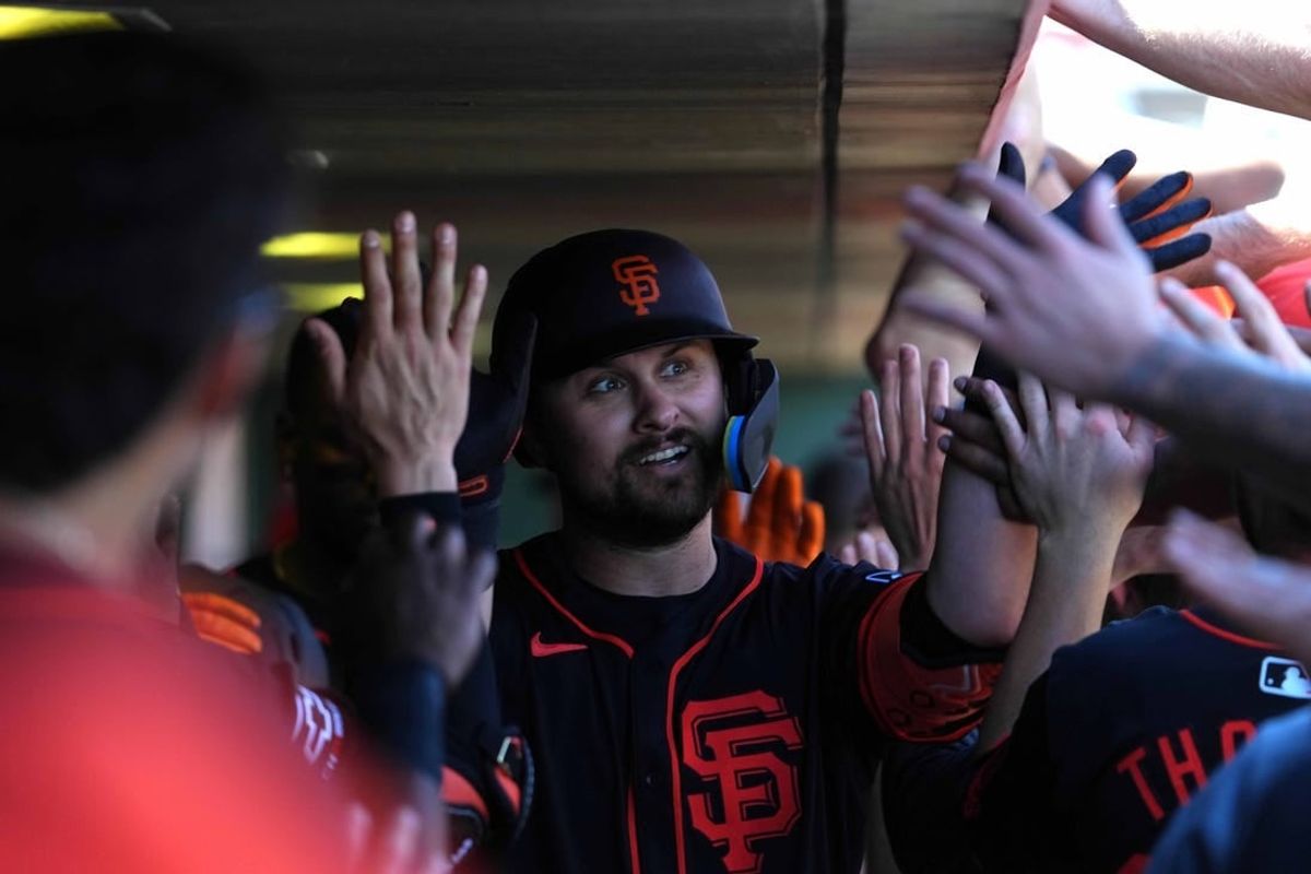 Mar 1, 2024; Scottsdale, Arizona, USA; San Francisco Giants first baseman J.D. Davis (7) celebrates with teammates after hitting a home run against the Texas Rangers during the second inning at Scottsdale Stadium.