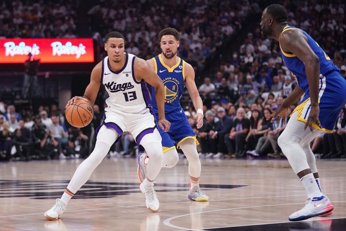 Apr 16, 2024; Sacramento, California, USA; Sacramento Kings forward Keegan Murray (13) dribbles the ball in front of Golden State Warriors guard Klay Thompson (11) in the first quarter during a play-in game of the 2024 NBA playoffs at the Golden 1 Center.