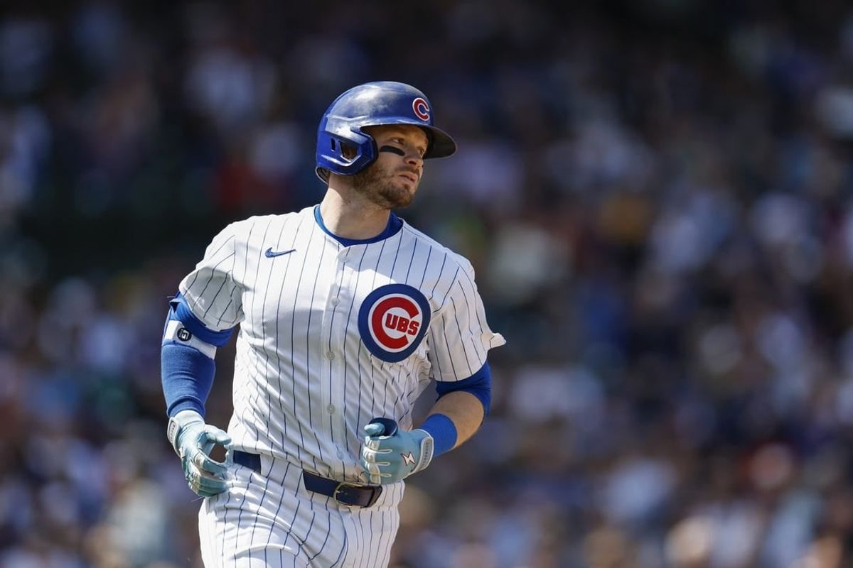 May 3, 2024; Chicago, Illinois, USA; Chicago Cubs outfielder Ian Happ (8) runs to first base after hitting a single against the Milwaukee Brewers during the fourth inning at Wrigley Field.