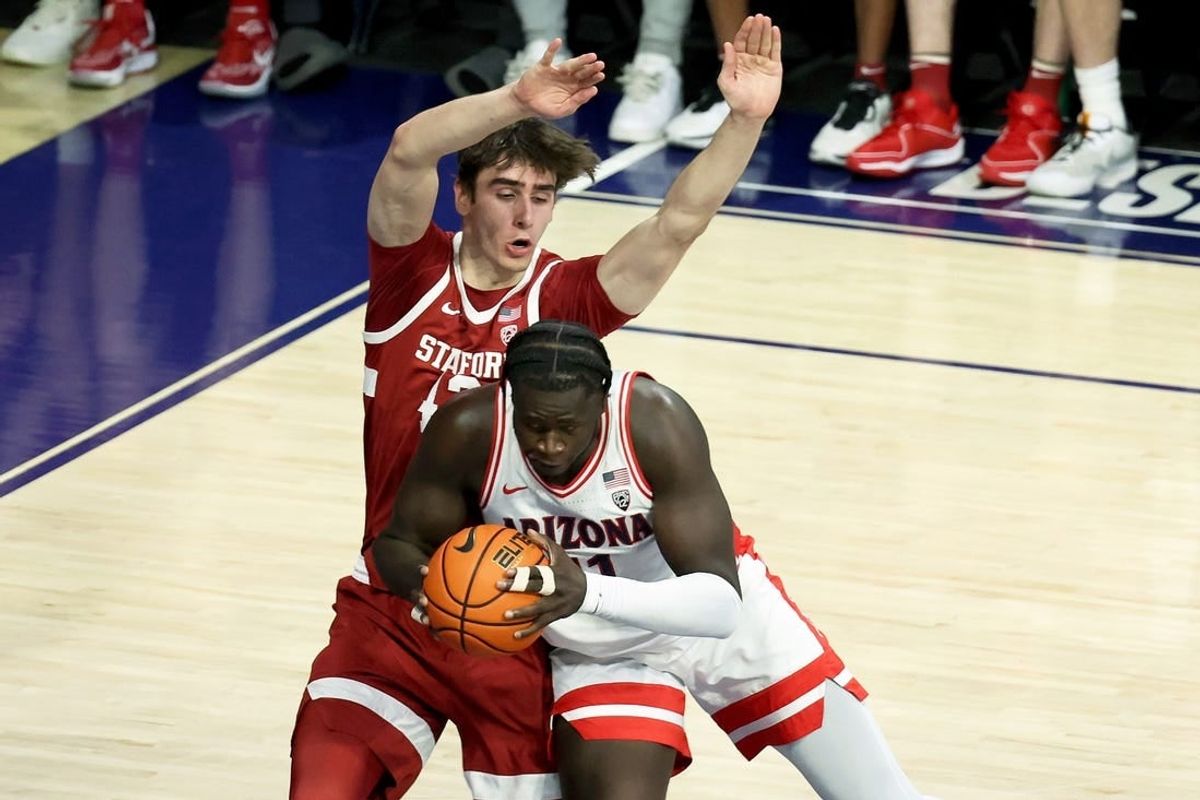 Feb 4, 2024; Tucson, Arizona, USA; Arizona Wildcats center Oumar Ballo (11) drives to the net against Stanford Cardinal forward Maxime Raynaud (42) during the first half at McKale Center.