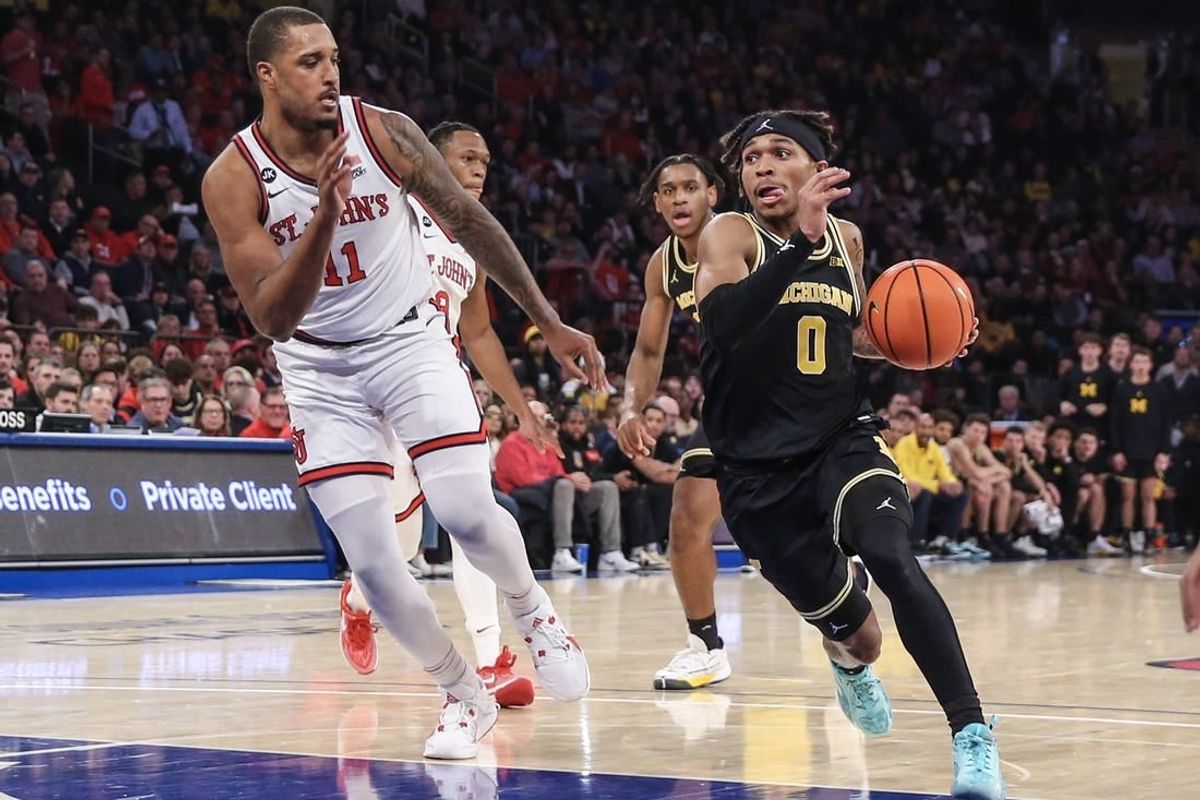 Nov 13, 2023; New York, New York, USA; Michigan Wolverines guard Dug McDaniel (0) drives past St. John's Red Storm center Joel Soriano (11) in the first half at Madison Square Garden.