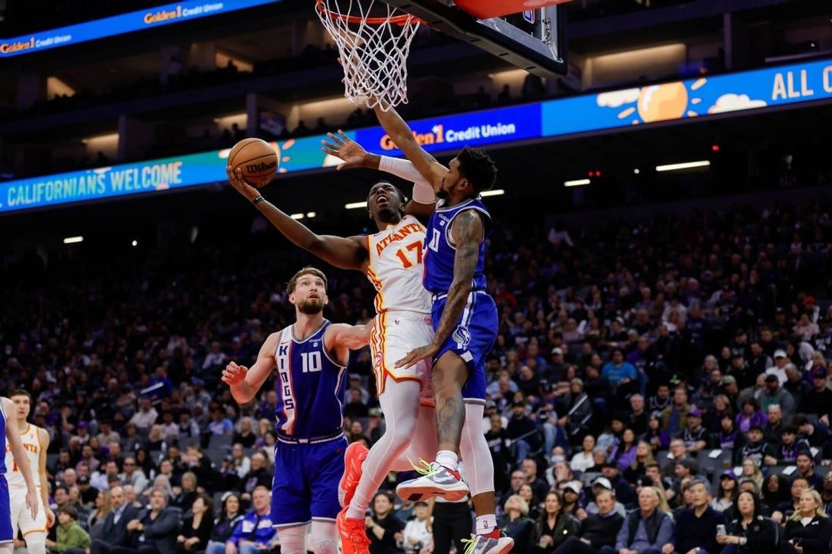 Jan 22, 2024; Sacramento, California, USA; Atlanta Hawks forward Onyeka Okongwu (17) drives to the basket against  Sacramento Kings guard Malik Monk (0) during the second quarter at Golden 1 Center.